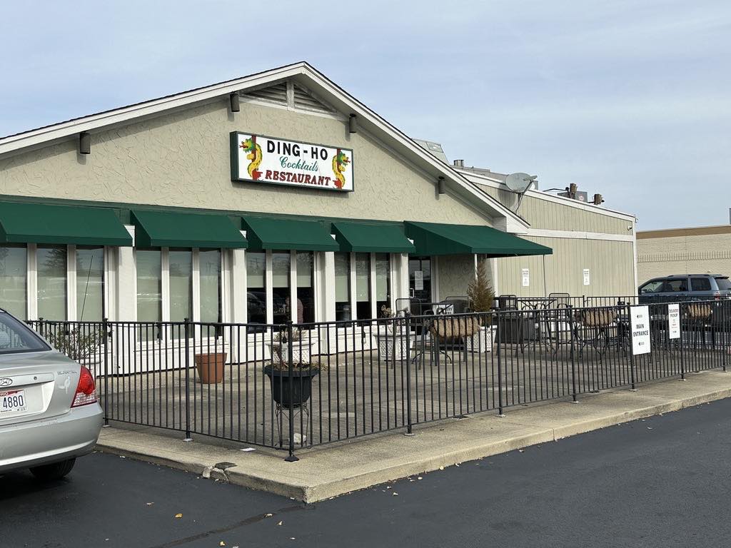 The Ding Ho restaurant sign and green awnings on the west side of Columbus